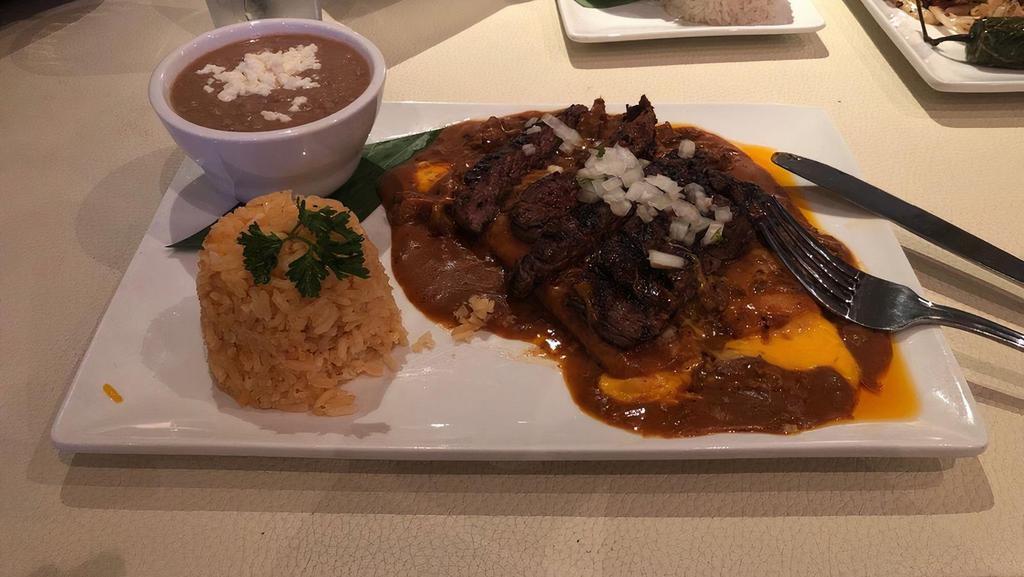 Enchilada Especiales · Two cheese enchiladas with chile con carne topped with beef or chicken fajitas + fresh onion on top.