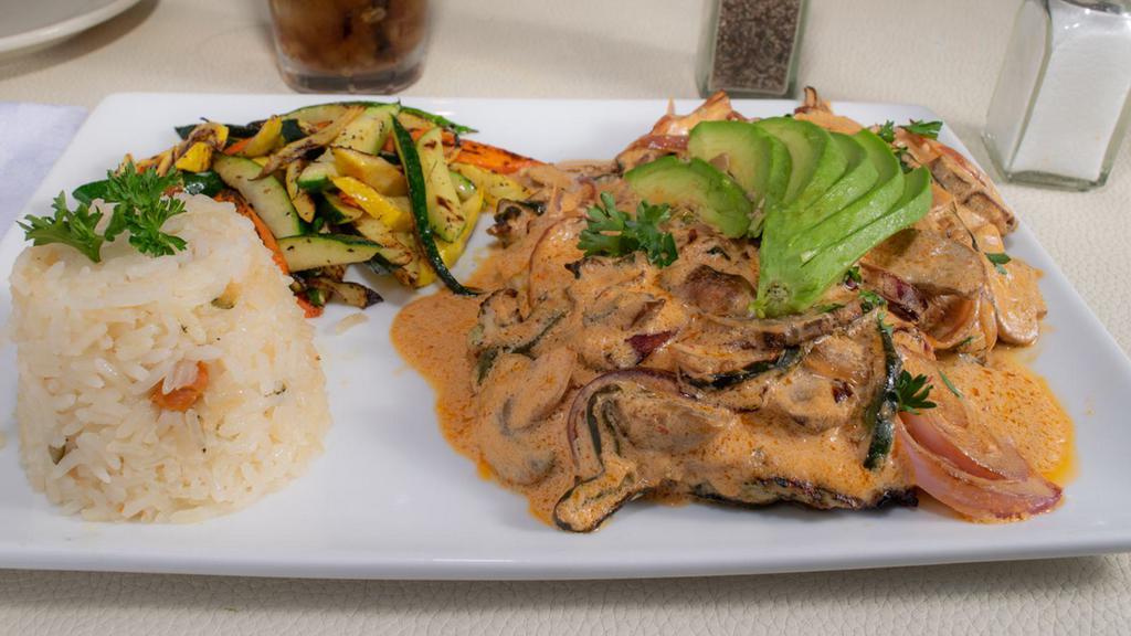 Lita'S Pollo Especial · Chicken breast topped with a cream sauce, sautéed poblanos, mushroom & onion with rice, vegetables and avocado slice.