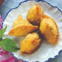 Samosa (2 Pc) (Vg) · Pastry puffs with potatoes & peas.