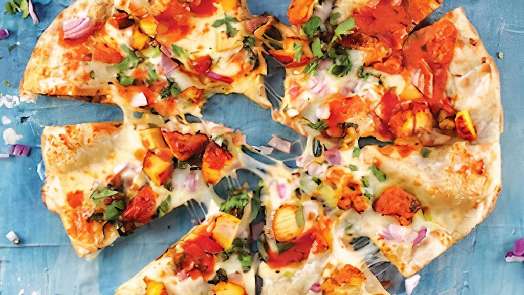 Tikka Pizza · Tikka Sauce, garlic, fresh mozzarella, red onions, tomatoes on a Naan crust topped with cilantro.