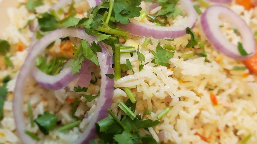 Biryani · Seasoned basmati rice, your choice of Vegetables  or paneer & veg., fine chopped green onions, red onions, fresh basil leaves, cilantro, crushed red pepper wok tossed with our authentic shorba sauce garnished with red onions & Cilantro. Served with shorba sauce and raita.