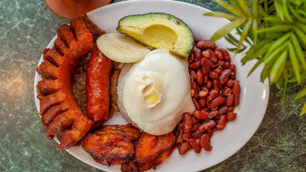 Bandeja Paisa · Colombia's Most Famous Dish! Fried Egg, Rice, Beans, Fried Plantains, Fried Pork Belly, Carne Asada, Colombian Sausage, Arepa, Avocado