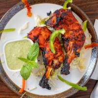 Tandoori Chicken · Leg quarters marinated in yogurt and mild spices, grilled in a Clay oven