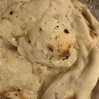 Garlic Naan · White flour hand tossed bread topped with garlic & cilantro, baked in clay oven
