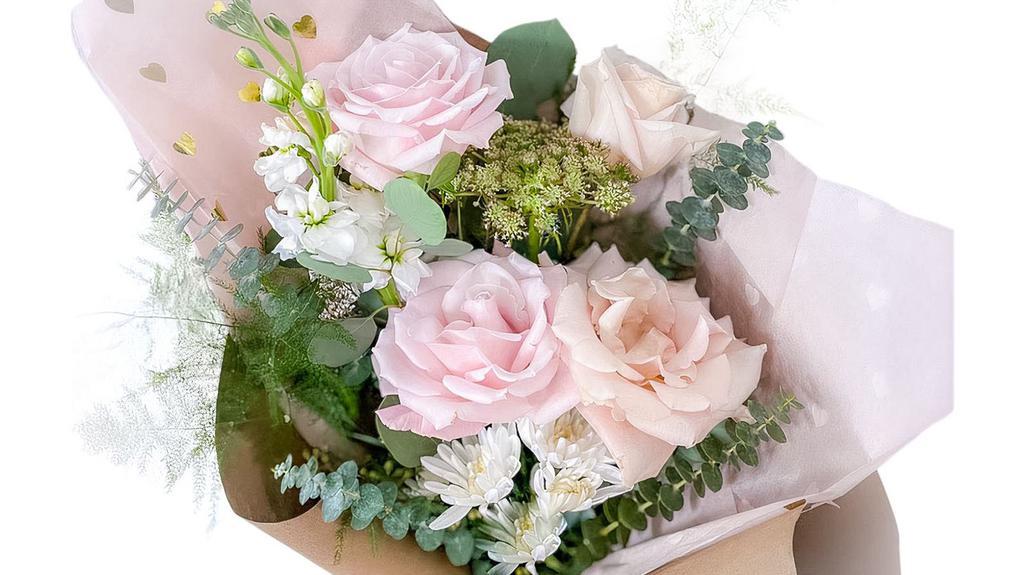 Small Handwrapped Bouquet · Arrangement of mixed flowers, greenery and roses.