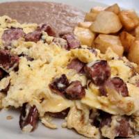Sausage And Egg Plate · SAUSAGE AND EGG MIXED SERVED WITH BREAKFAST POTATOES, REFRIED BEANS AND TWO TORTILLAS ON THE...