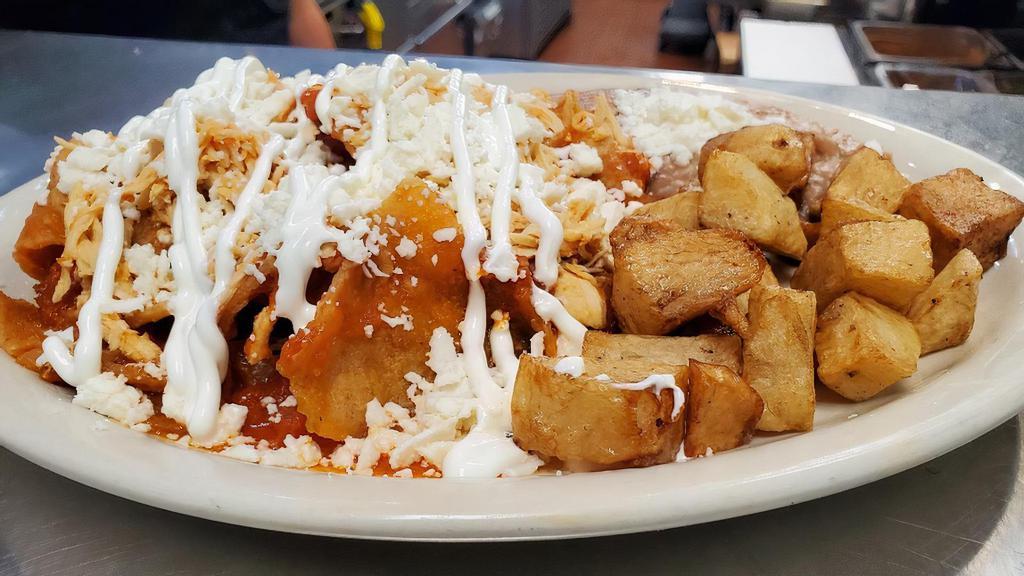 Chilaquiles With Chicken · TORTILLA CHIPS WITH SAUCE OF YOUR CHOICE, QUESO FRESCO, SOUR CREAM AND SHREDDED CHICKEN BREAST ON TOP, SERVED WITH REFRIED BEANS, BREAKFAST POTATOES AND TWO TORTILLAS ON THE SIDE .