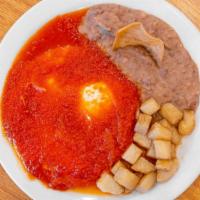 Huevos Rancheros · THREE EGGS WITH RANCHERO SAUCE ON TOP, SERVED WITH BREAKFAST POTATOES, REFRIED BEANS AND TWO...