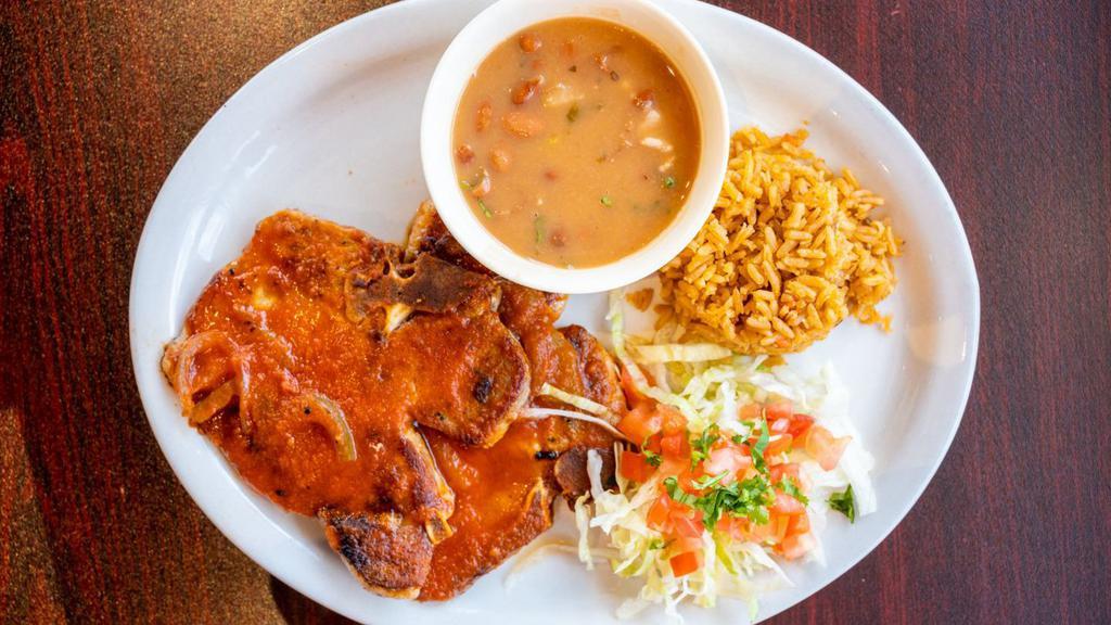 Pork Chop Ranchero · TWO PIECES OF GRILLED PORK CHOP TOPPED WITH RANCHERO SAUCE, SERVED WITH CHARRO BEANS, RICE AND TWO TORTILLAS.