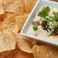 Hot Link Queso Dip · Smoked Louisiana hot link, pimento pepper jack cheese sauce, queso fresco, green onions, whi...