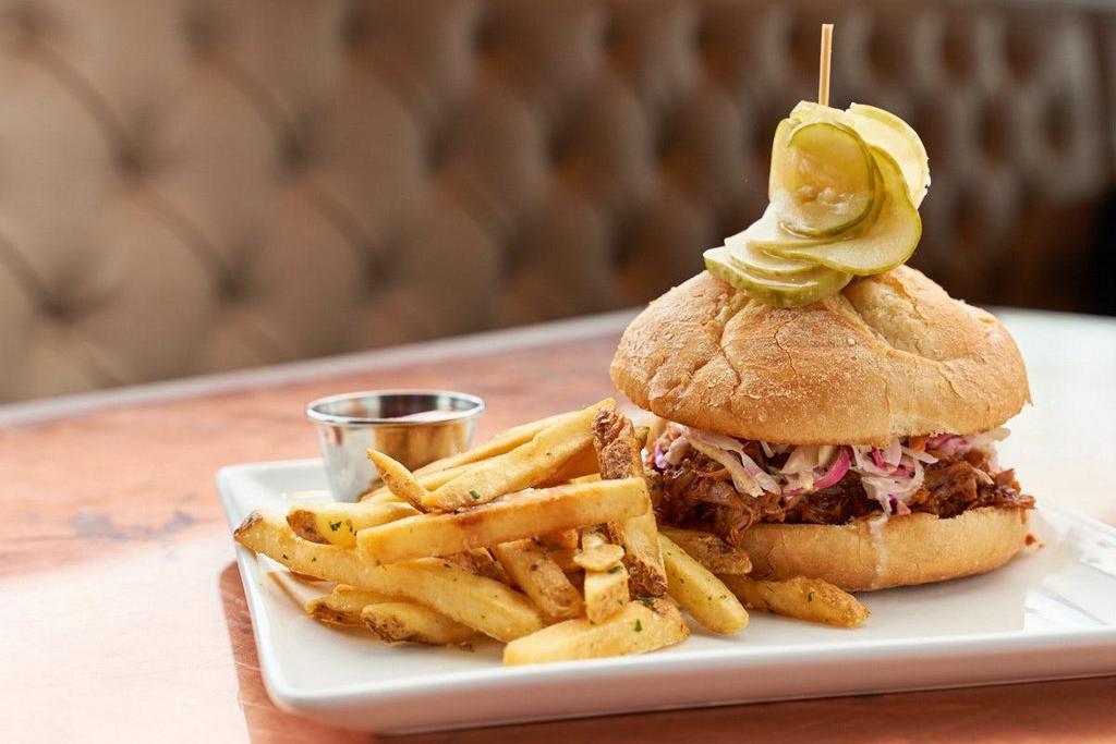 Pulled Pork · Hand pulled and house smoked pork shoulder, housemade BBQ sauce, cider mustard, coleslaw, spicy bread and butter pickles, kaiser roll.
