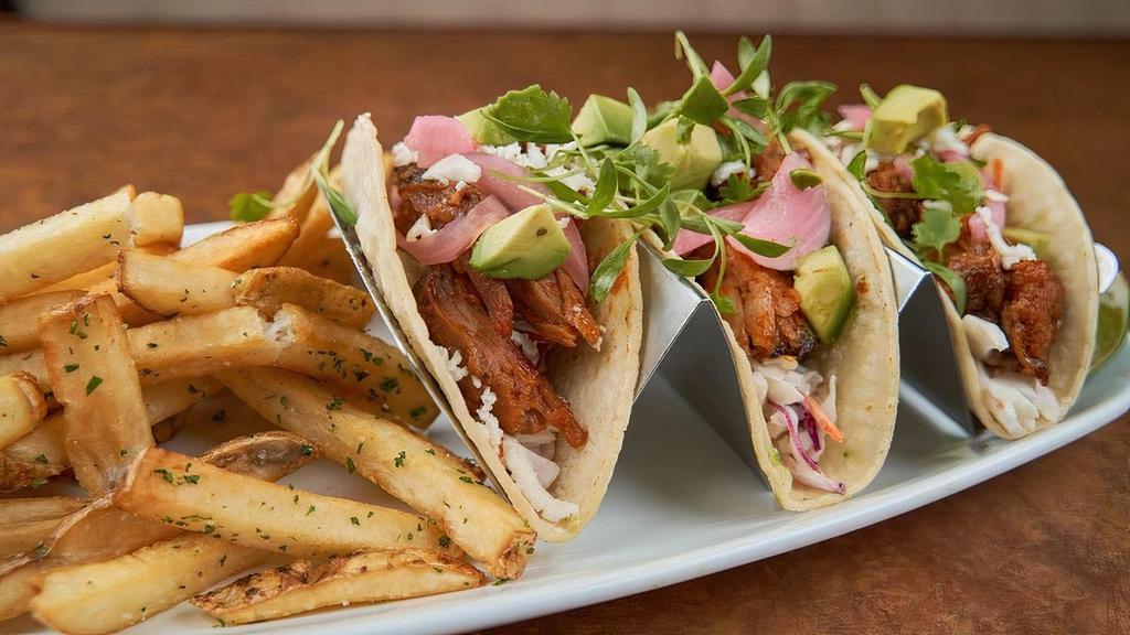 Bbq Pork Tacos · Hand-pulled and house-smoked pork shoulder, housemade BBQ sauce, classic slaw, pickled red onions, queso fresco, avocado, white corn tortillas, micro cilantro.