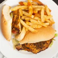 Oak Street Cajun Po Boy · Toasted french bread. Served with lettuce, tomato, pickles, and shuck sauce. Served with fre...