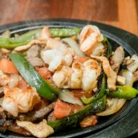Los Rancheros Fajitas · Grilled Steak, chicken and shrimp with grilled onions, grilled tomatoes and grilled green pe...