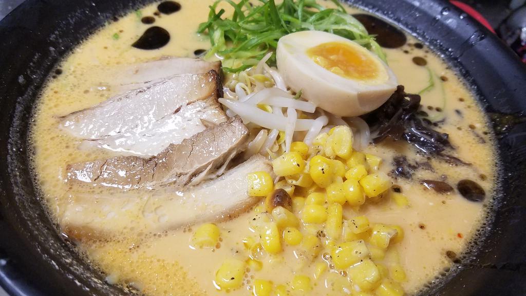 Miso Ramen · Pork based broth with miso, chashu, soft-boiled egg, green onion, black mushroom, bean sprouts, buttered com, garlic oil.