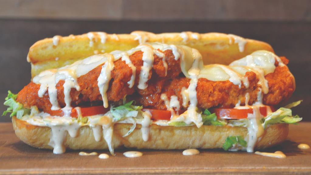 Buffalo Chicken Philly · Hand breaded buffalo chicken tenders topped with provolone cheese, shredded lettuce, tomato, chipotle ranch and lucky aioli sauce. Served on a traditional hoagie roll.