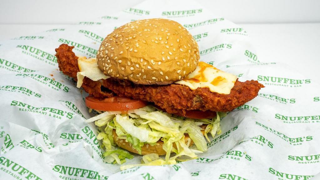Nashville Hot Chicken Sandwich · Crispy fried chicken breast smothered in Nashville hot sauce, chopped lettuce, pickles, whipped goat cheese spread on a locally-sourced bun