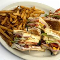 Triple Decker Club Sandwich · Deli sliced ham and smoked turkey with applewood bacon strips, aged cheddar and Swiss cheese...