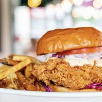 Southern Crispy Chicken Sandwich · Battered and fried chicken breast topped with ranch dressing, red cabbage, tomato, and red o...