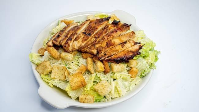 Chicken Strip Caesar Salad · Romaine hearts tossed in Caesar dressing with croutons and parmesan cheese. Choice of marinated, fajita, or crispy fried chicken.