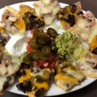 Nachos Supreme  · Nachos Individually topped with refried beans, your choice meat and melted shredded cheese.