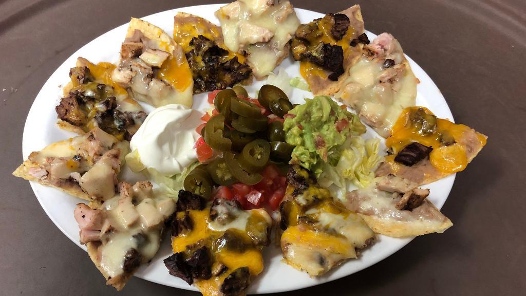 Nachos Supreme · Individual tortilla chips topped with refried beans, your choice of beef or chicken fajita and shredded melted cheese. Served with Guacamole, Sour Cream and Jalapenos on the Side