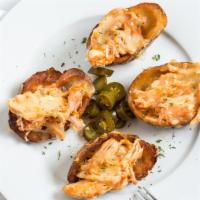 Potato Skins · Four deep fried potato skins served with melted cheddar, white cheese, sour cream, guacamole...