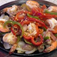 Camarones Al Ajillo · Sautéed shrimp in garlic virgin olive oil, red and white onions, bell peppers and lemon pepp...