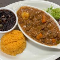 Carne Guisada · Beef stew served with rice, beans, guacamole, pico de gallo and tortillas.