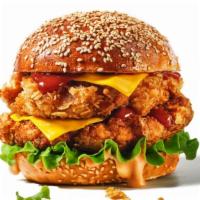 Cheesy Double Chicken Sandwich · Delicious sandwich made with 2x the Fried chicken and melted cheese, lettuce, pickles, tomat...