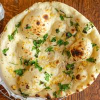Garlic Naan · Leavened white bread stuffed with crushed garlic and coriander baked in the clay oven.