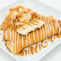 Lotus Crepe · Fluffy crepe filled with bananas topped with Biscoff cookie, Lotus Biscoff crumbs and Lotus ...