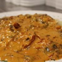 Chicken Sunrise · Sautéed chicken breast with mushrooms, sundried tomatoes in a brandy cream sauce with a touc...