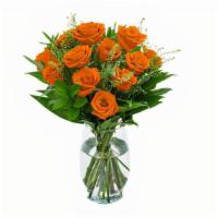 Unforgettable Arrangement (Orange) · A Dozen Orange Roses with greenery and filler in a clear vase.