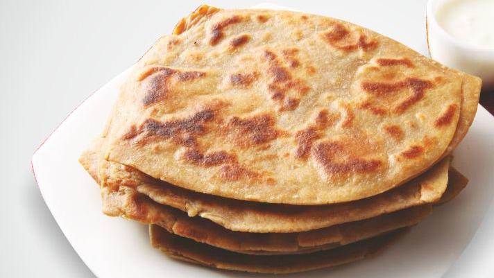 Plain Paratha · A layered flatbread made with flour, salt, water and ghee (Oil). Our plain paratha's are made in triangular shape.