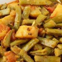 Aloo Guvar · Potatoes and Guvar beans cooked with onions, tomatoes, ginger garlic paste and our special b...