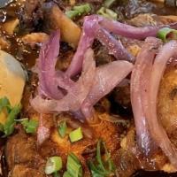 Adobo · Gluten-Free. Chicken leg quarters braised in a tangy savory marinade, sautéed red onion, boi...