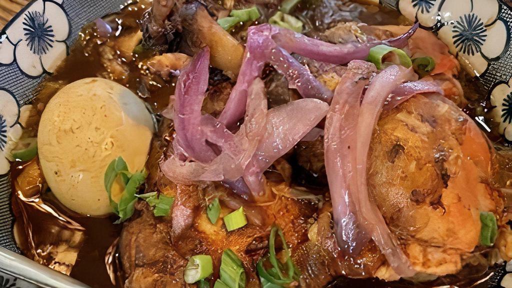 Adobo · Gluten-Free. Chicken leg quarters braised in a tangy savory marinade, sautéed red onion, boiled egg, green onion, with white rice.