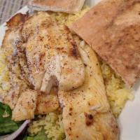 Tilapia Plate · Grilled tilapia fillet. Served on a bed of rice with Mediterranean salad.