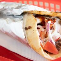 Beef Shawarma Wrap · Beef marinated, thin sliced wrapped in a pita bread with tomato, onions, and our white sauce...