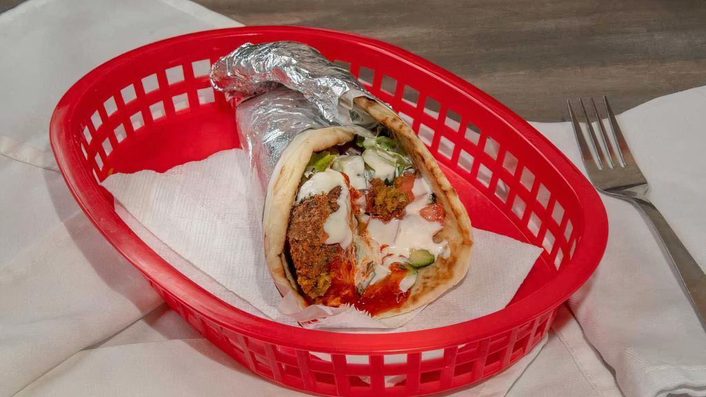 Falafel Wrap · Mixed vegetables and special spices combined to create a delicious deep fried veggie balls made fresh to order wrapped in pita bread. Served with our white sauce and hot sauce.
