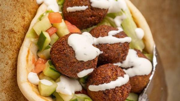 Gyro & Falafel Wrap · Gyro and fried veggie balls with lettuce, tomato, cucumbers, and our white sauce and hot sauce.