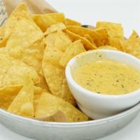 Chile Con Queso · Chile con queso, served with tortilla chips. All of our appetizers are handmade with a uniqu...