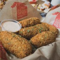 Poppers · Breaded, roasted jalapenos stuffed with cream cheese.