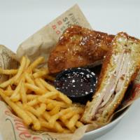 Monte Cristo Sandwich · Smoked ham, turkey, and Swiss cheese, battered and fried, topped with powdered sugar served ...