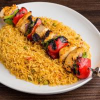 Espetada · Flame-grilled per chicken skewered between layers of bell peppers and onions.