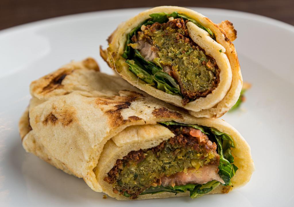 Falafel Pita · Grilled Chickpea falafel fried falafel patties, lettuce, tomato and garlic sauce wrapped a  in a toasted pita.