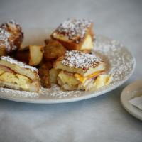 Breakfast Monte Cristo- · Our Creamy French Toast Stuffed With Cheddar, And Fontina Cheese, Scrambled Eggs, Warm Turke...