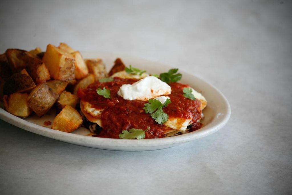 Huevos Rancheros- · Grilled Corn Tortillas Stacked With Our House Made Black Beans, Mozzarella Cheese, And House Made Ranchero Sauce, Topped With 2 Eggs, Sour Cream And Fresh Cilantro. Served With Breakfast Potatoes