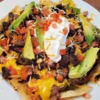 Nachos Supreme · (chicken or steak) Refried beans, cheese sauce, tomatoes, jalapenos, mixed cheese, sour crea...